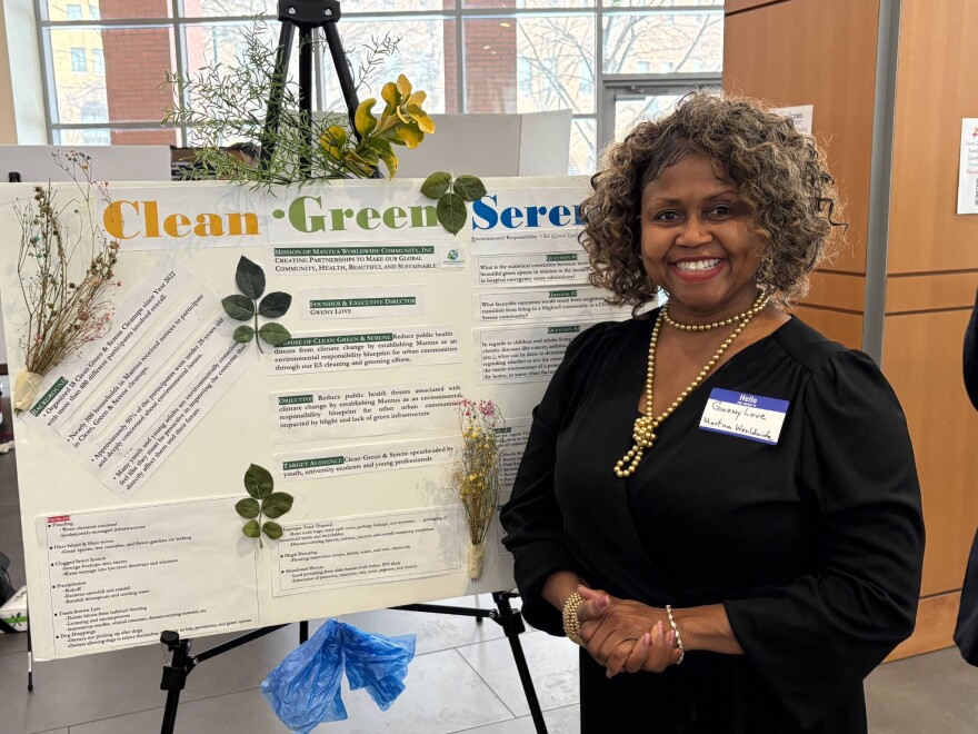  Gweny Love poses in front of a display.