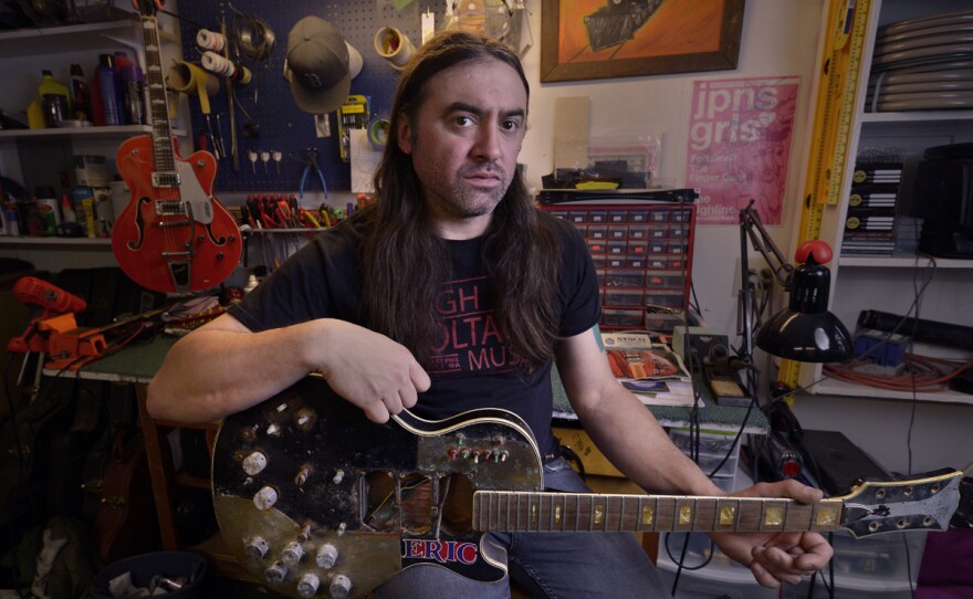 High Voltage Music co-owner Chris Lomba in his backyard shop in north Seattle.