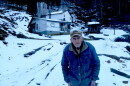 Fred Stikes of Ashe County stands in front of the dirt road leading to his family's homestead, Stikes Hollow, in January. The bridge over Buffalo Creek connecting the home to Highway 88 was severely damaged by Helene's flood waters. Volunteers from Lansing's Bridge to Recovery repaired the crossing. PAUL GARBER/WFDD