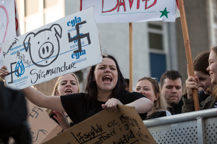 A protester in Reykjavik on April 4, 2016 holds up a sign displaying her anger with Iceland's Prime Minister Sigmundur Davíð Gunnlaugsson announced he would take a leave of absence after being linked to the Panama Papers.