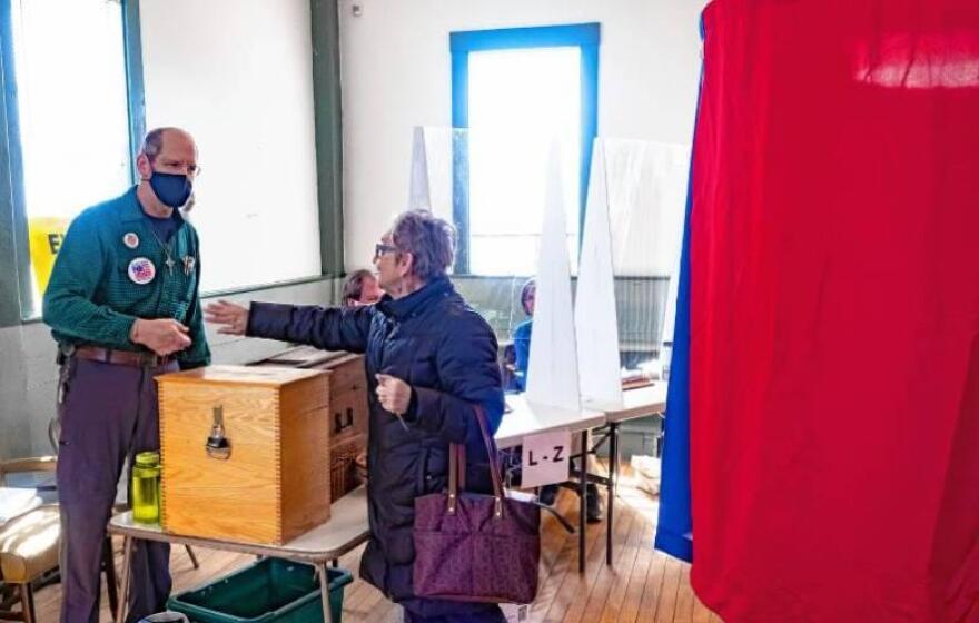 Canterbury resident Sandy Hodsdon says goodbye to town moderator Jim Miller after voting at the town hall on Tuesday, March 8, 2022. (Concord Monitor file photo)