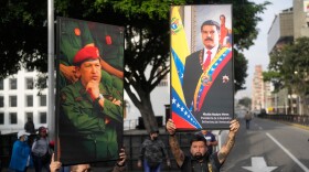 Government supporters display posters of Venezuelan President Nicolás Maduro, right, and former President Hugo Chávez in downtown Caracas, Venezuela, Saturday, Jan. 3, 2026, after U.S. President Donald Trump announced that Maduro had been captured and flown out of the country. (AP Photo/Matias Delacroix)