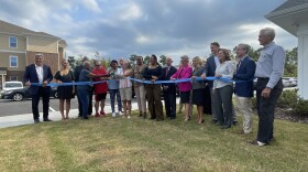 New Hanover County Commissioners: Rob Zapple, Jonathan Barfield (left), Bill Rivenbark (center); Democratic Rep. Deb Butler (center), and Republican Senator Michael Lee (right); Norco Management Developer, Stephanie Norris (right); and residents: John Lizzio and Marsha Barfield (left) at the ribbon-cutting of Estrella Landing.
