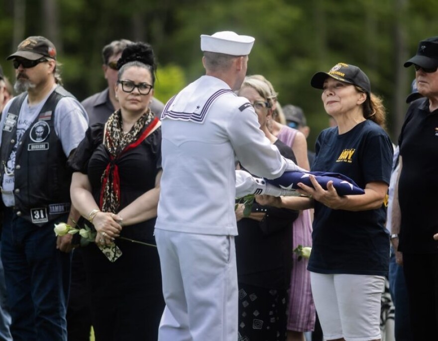 U.S. Navy veteran Valerie Ellmer accepts flag during the ceremony to honor U.S. Navy Veteran John W. Mulligan with military honors at the New Hampshire Veterans Cemetery in Boscawen on Thursday, June 11, 2026. (Concord Monitor)