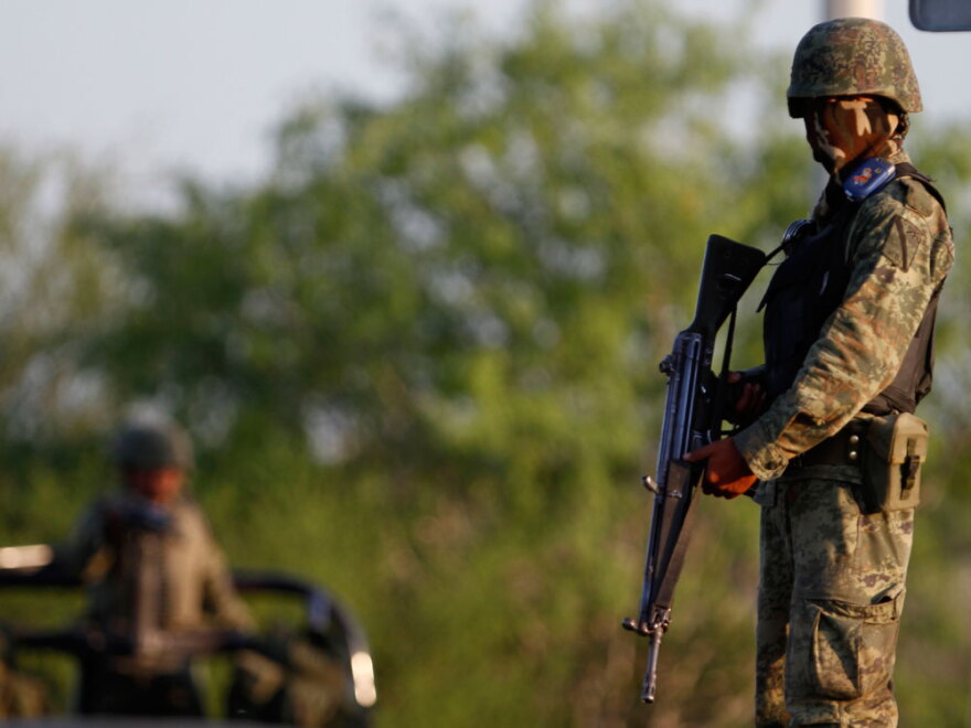 A soldier stands guard at a crime scene in Monterrey.