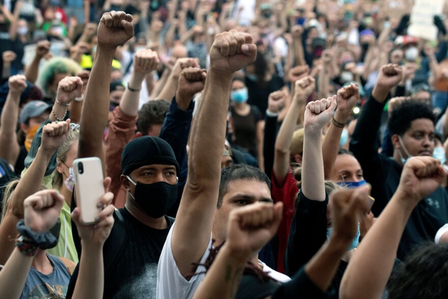 Demonstrators raise their fists in a sign of solidarity while protesting the death of George Floyd, an unarmed black man who died while while being arrested and pinned to the ground by the knee of a Minneapolis police officer, at the  Colorado State Capital in Denver, Colorado on June 3, 2020. (Jason Connolly/AFP) 