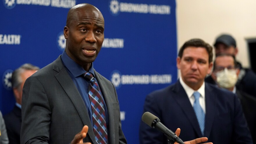 Florida Surgeon Gen. Dr. Joseph A. Ladapo, left, speaks at a news conference with Florida Gov. Ron DeSantis, right, Monday, Jan. 3, 2022, at Broward Health Medical Center in Fort Lauderdale.