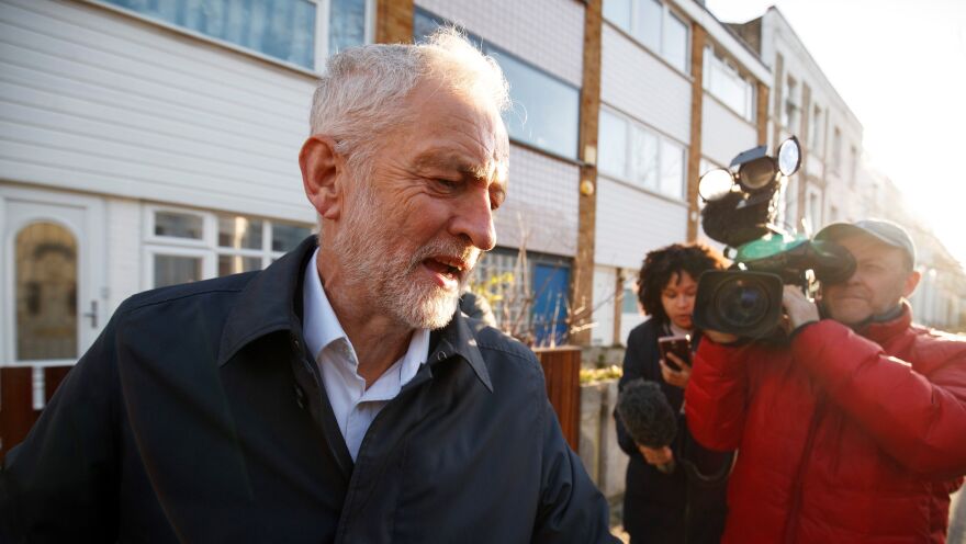 Labour Party leader Jeremy Corbyn leaves his home in London on Monday, surrounded by journalists.