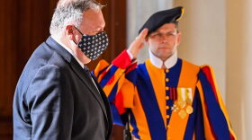 US Secretary of State Mike Pompeo walks past a Swiss Guard as he arrives at San Damaso courtyard in The Vatican for meetings with The Vatican's Secretary of State, and The Vatican's Secretary for Relations with States.