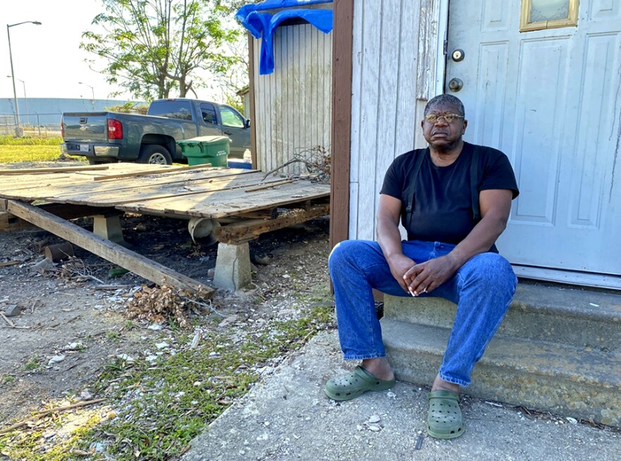 Michael Coleman sits in front of his home in Reserve, La. The house is the only one still standing on a residential street that sits next to the Marathon Petroleum refinery.