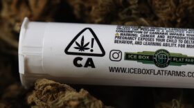In this photo illustration, packaging for a marijuana cigarette sits on top of dried cannabis flowers in San Anselmo, California.