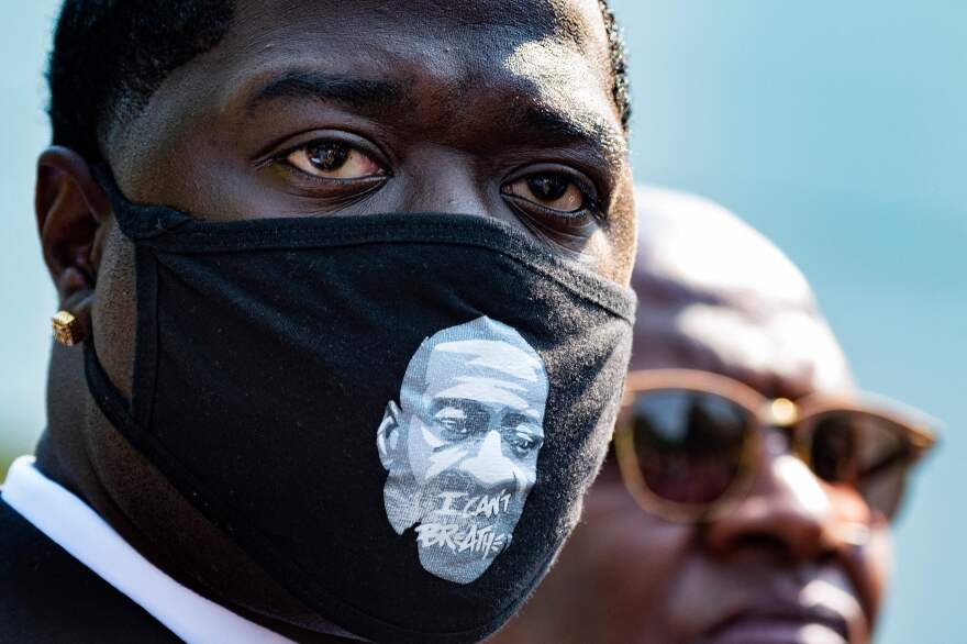 Brandon Williams, Floyd's nephew, looks on outside the White House as family members speak with reporters Tuesday after the meeting.