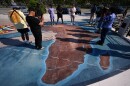 A group of people visit a memorial built on the site where hundreds of Africans who died in 1860 
