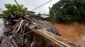 Debris from a storm-damaged house sits against a bridge along Kaukonahua Stream, caused by flooding from severe rains in Waialua, Hawaiʻi, Friday, March 20, 2026.