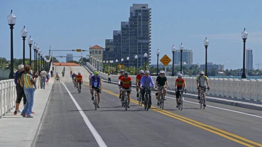 Cyclists ride on the Venetian Causeway bridge just before it reopens to car traffic after nine months of construction in 2016.