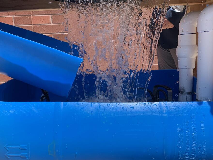 water flowing the students' storm drain prototype