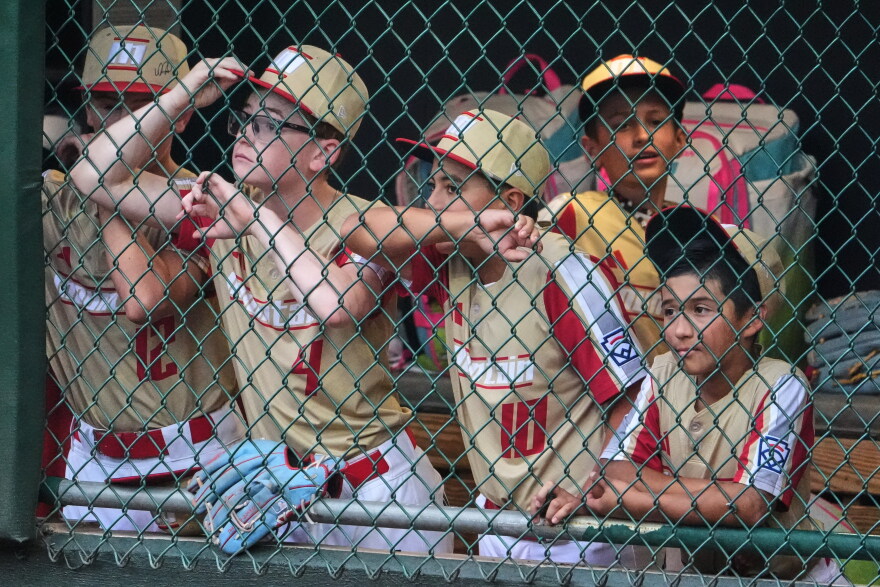 Members of the Little League team from Henderson, Nev., stand in their dugout during the sixth inning of the Little League World Series Championship baseball game against Curacao in South Williamsport, Pa., Sunday, Aug. 30, 2026. (AP Photo/Gene J. Puskar)