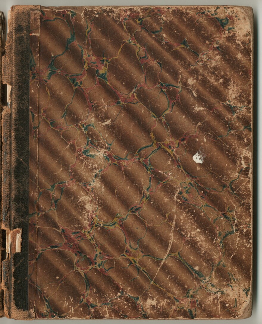 A picture of a brown leather bound book.