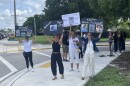 Friends and family of Claudia Carolina Rodriguez Caglianone wave signs outside of the Broward Transitional Center, a for-profit detention facility funded by U.S. Immigration and Customs Enforcement (ICE) in Pompano Beach.