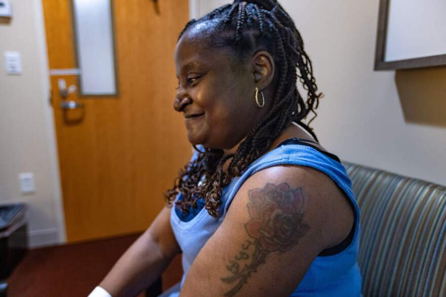 Pearlie Rose Burke smiles as she recalls the first time Dana Farber Cancer Institute chaplain Larisa Waya saw Burke's tattoo. (Jesse Costa/WBUR)