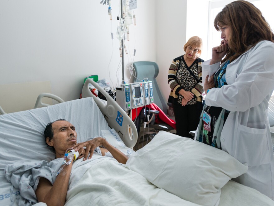 Dr. Carin van Zyl talks to patient Jose Garcia Flores about his treatment options for his advanced stage colon cancer in October.