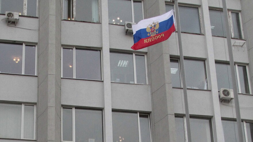 A Russian flag flies outside the state and city administration building in the Crimean city of Sevastopol on Monday.