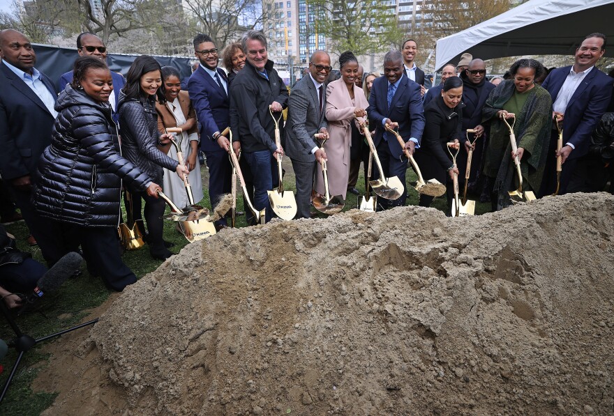 Officials, organizers and supporters participate in a groundbreaking ceremony for "The Embrace" Martin Luther King monument on the Boston Common in Boston on Wednesday.