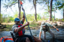 A Heroes on the Water volunteer helps a veteran during a 2021 river trip.