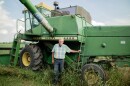 Dennis Kellogg proudly stands next to his John Deere combine from the 1970s. He said he'll use this equipment to harvest his crop later this year. 