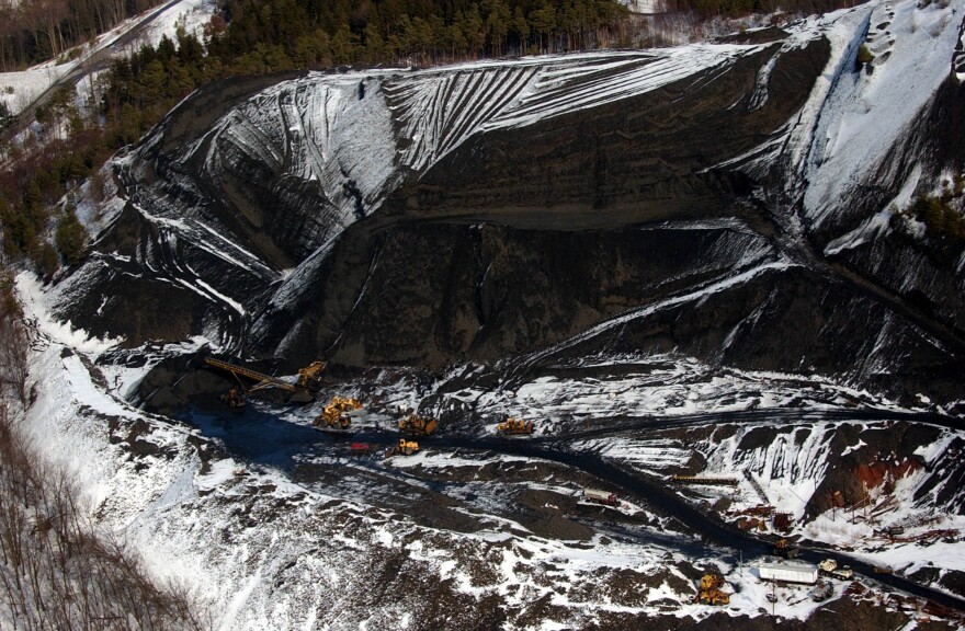 In this file photo from 2004, a huge pile of waste coal is being remined in Shamokin, Pa., and sent to area power plants.