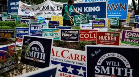 Campaign signs compete for space during the first day of early voting in the state outside the Silver Spring Civic Building at Veterans Plaza in Silver Spring, Maryland. 
