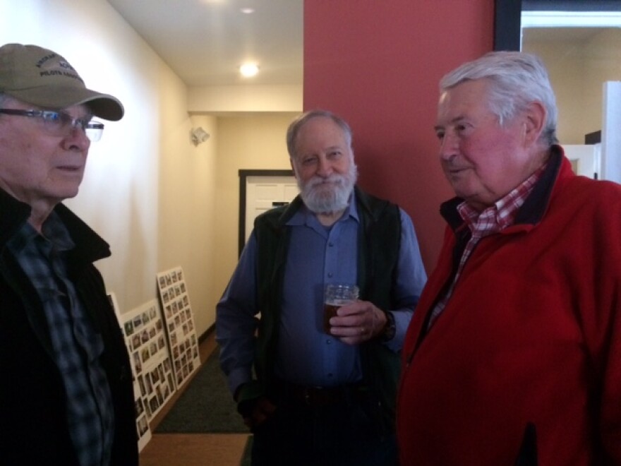 Richard Svec, center, holding a drink at his retirement party in 2017.