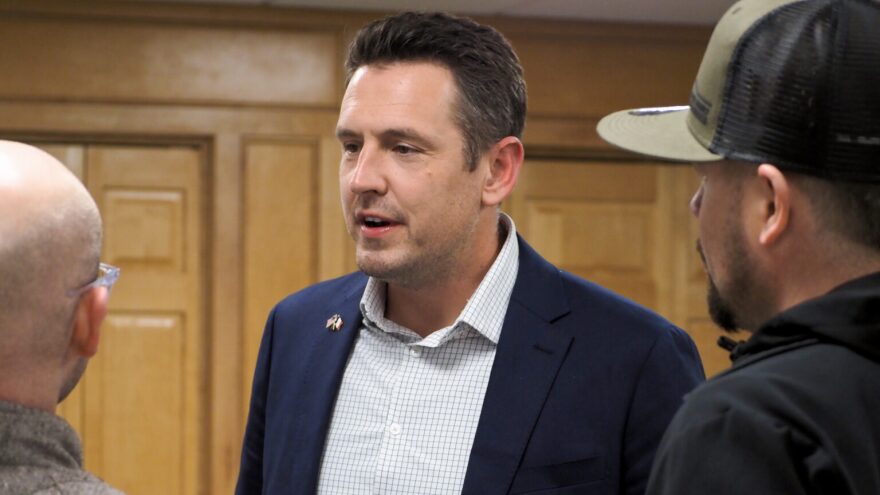 Zach Lahn, a Republican gubernatorial candidate in Iowa, has a significant association with Kansas as co-founder of a Wichita school in 2018 and as a registered voter in the state until 2024. His "Iowa First" platform will be put to a test Tuesday in the primary election. In this image from April 2, 2026, Lahn chats at opening of his West Des Moines campaign headquarters.