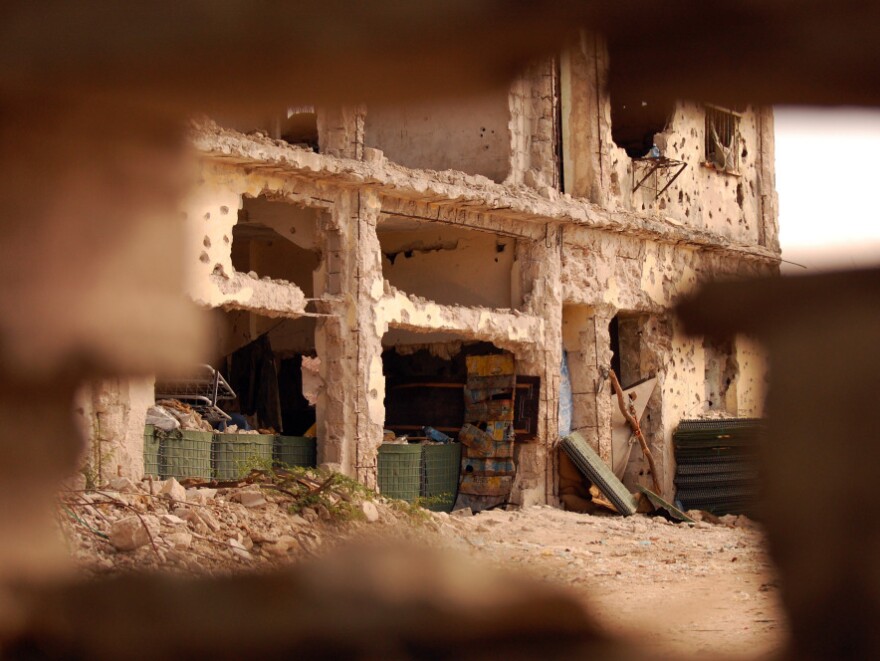 The view through the wall of a bombed-out villa  in an abandoned neighborhood in Mogadishu.