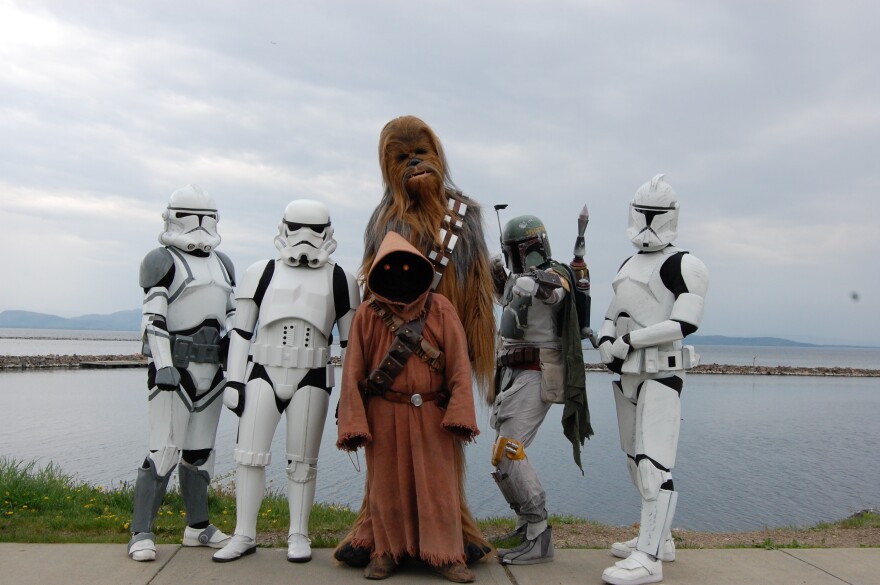 Six people dressed as Star Wars characters stand in front of Lake Champlain.