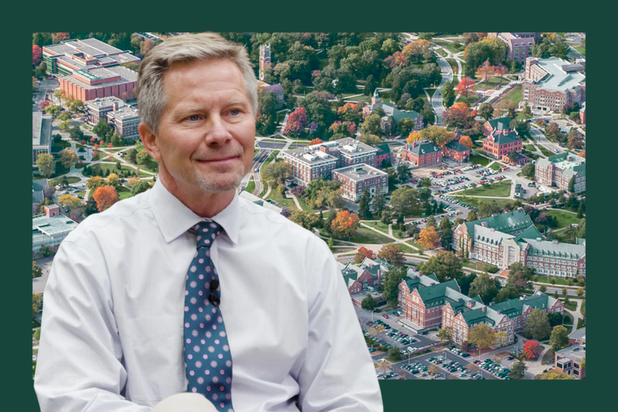 Photo of Kevin Guskiewicz with the MSU campus in the background. 