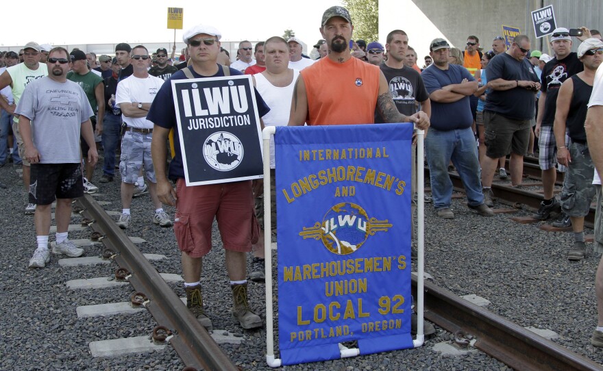 Union workers block railroad tracks in Longview, Wash., Wednesday. Longshoremen blocked a train carrying grain as part of an escalating dispute about labor at the EGT grain terminal at the Port of Longview.