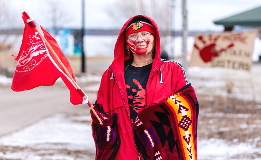 Lori Ah-shein holds a MMIW flag at the eighth annual Missing and Murdered Indigenous Women's ceremony and walk. The event was held at the Bemidji Waterfront on Wednesday, Feb. 14, 2024.