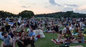 People sit on the grass in Zilker Park on the second night of Austin City Limits Radio’s Blues on the Green concert on July 28, 2021.