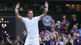 Britain's Andy Murray waves to the Center Court crowd as he leaves following his first round doubles loss at the Wimbledon tennis championships in London, Thursday, July 4, 2024. (AP Photo/Kirsty Wigglesworth)