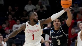 Houston guard Jamal Shead (1) grabs a loose ball away from Longwood guard DA Houston (3) during the first half of a first-round college basketball game in the NCAA Tournament, Friday, March 22, 2024, in Memphis, Tenn. 