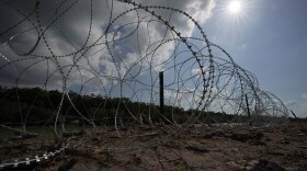Concertina wire lines the banks of the Rio Grande on the Pecan farm of Hugo and Magali Urbina, near Eagle Pass, Texas, Monday, July 7, 2023. A dispute over razor wire that Texas installed on the U.S.-Mexico border to deter migrants continued Thursday, Nov. 30, 2023, after a judge allowed Border Patrol agents to continue cutting the barrier but also laid into the Biden administration over immigration enforcement.