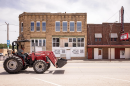 A man drives heavy machinery through downtown Fairfax, Oklahoma. The small town was at the center of many of the murders of Osage people in the 1920s, an atrocity depicted in the movie "Killers of the Flower Moon." 