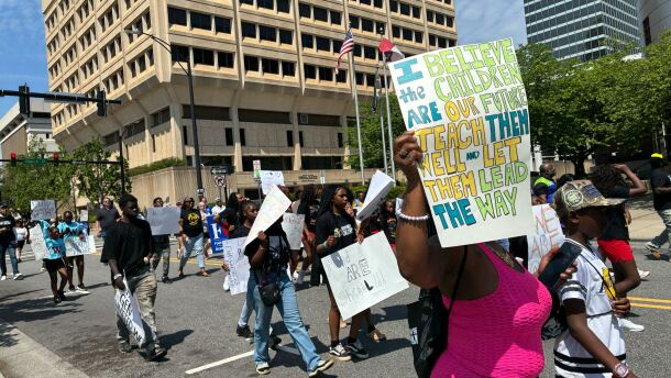 Hundreds march through downtown Winston-Salem holding signs