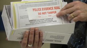 This Feb. 8, 2017, photo, Utah State Crime Lab Director Jay Henry holds a sexual assault evidence collection kit following a committee meeting at the Utah State Capitol, in Salt Lake City. Utah crime lab officials are feeling optimistic as they work to speed up the time it takes to process sexual assault evidence kits, after lawmakers approved a measure last month that sends more than $1 million to go toward this effort. (AP Photo/Rick Bowmer)