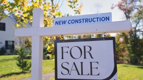 A sign is posted for a new home for sale