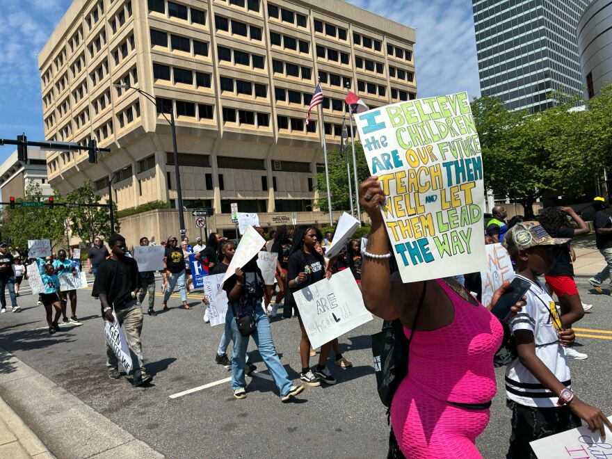 Hundreds march through downtown Winston-Salem holding signs