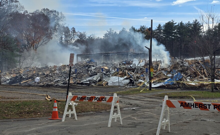 After a blaze caused the partial collapse and tear-down of an apartment complex in Amherst, Massachusetts , the remains still smoking,  on November 9, 2025. 