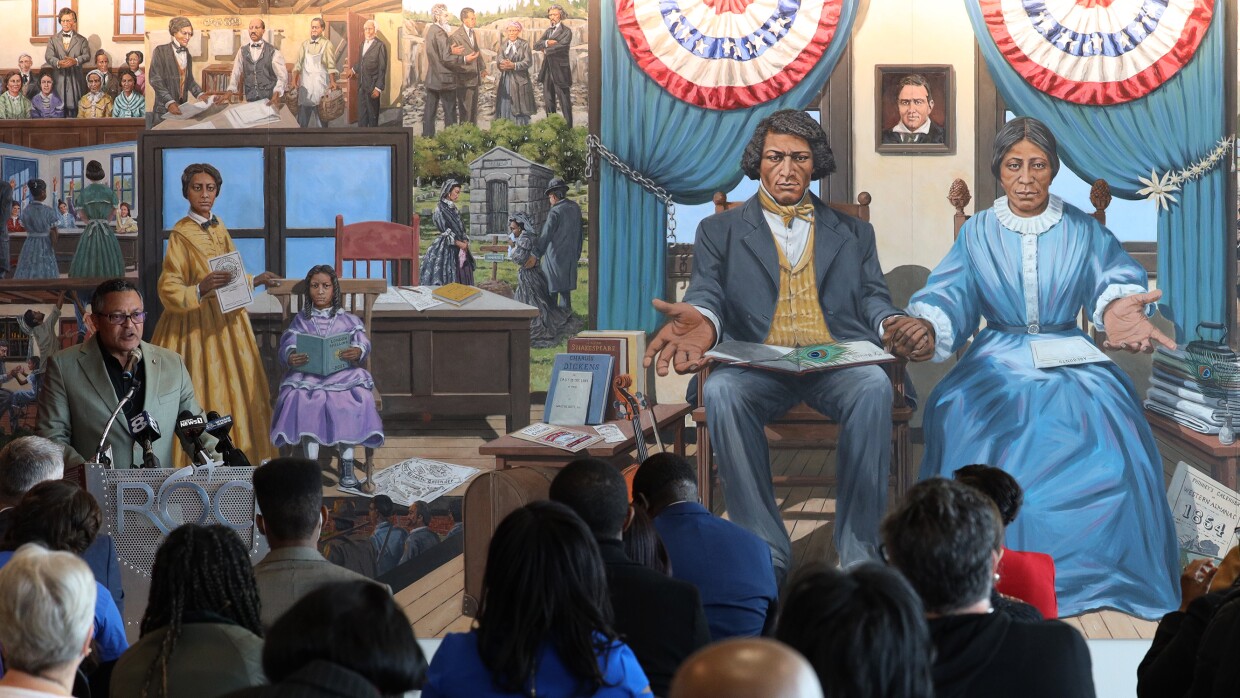 Kenneth Morris, a descendant of Frederick Douglass, with the mural that was unveiled honoring Douglass, his family and those who kept his legacy alive.