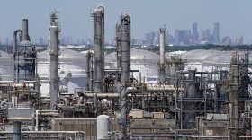  In this Thursday, April 30, 2020, photo a refinery along the Houston Ship Channel is seen with downtown Houston in the background.&#13;
